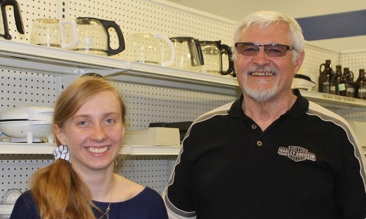 Student volunteer Keona Sturby and MCC Thrift Store acting general manager Gerald Loeppky.