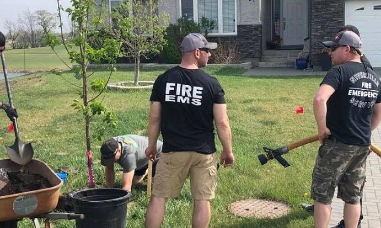 On a previous year's tree-planting day, volunteers from the Niverville Fire Department arrive to water new trees.