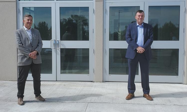 Dr. Kenton Anderson, President of Providence University, and Niverville Mayor Myron Dyck announce a partnership agreement for use of the CRRC fieldhouse.