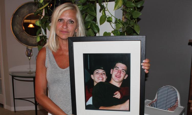 Mona Stott holds up a picture of her children, Danielle and Joey.