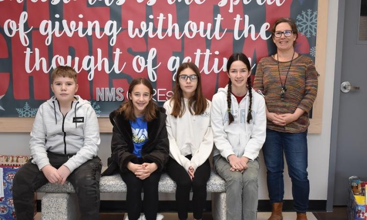 Members of SWAG, alongside teacher Laura van den Brul, on the school’s new bench.