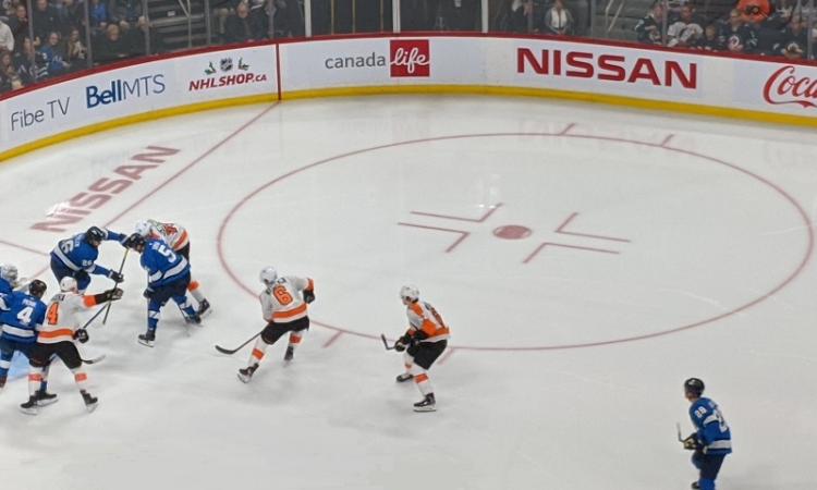 The Jets defend against the Philadelphia Flyers at Bell MTS Place.