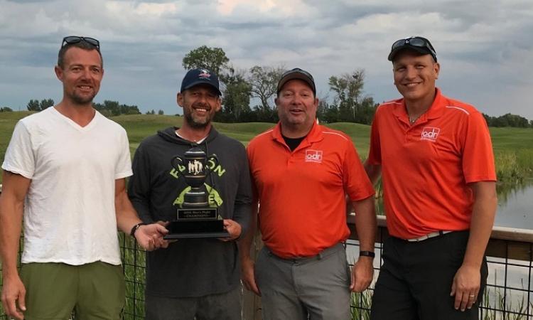 Cory Funk and Kurt Funk receive their championship trophy from last year’s winners, Bryan Trottier and Ray Dowse.