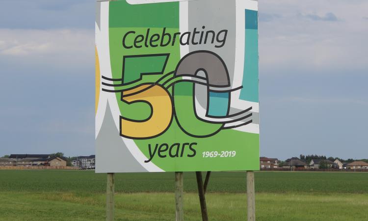 Fiftieth anniversary signs greet visitors to Niverville at either end of town.