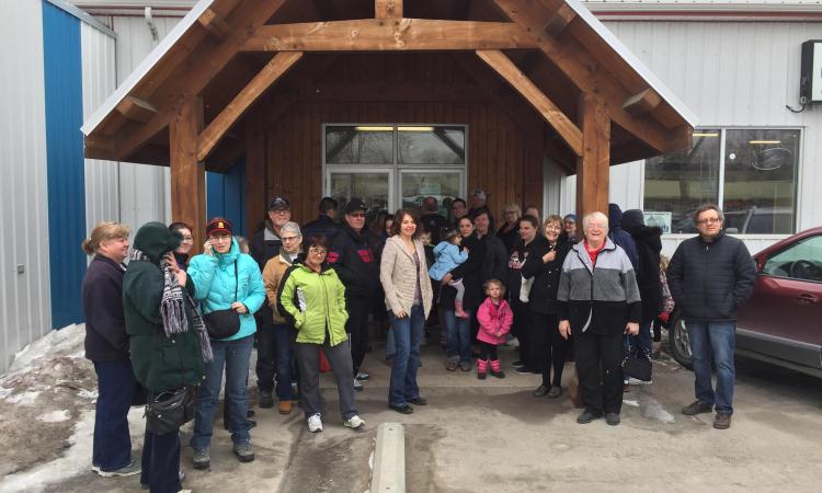 A crowd of eager shoppers gathers outside the thrift store on a chilly Tuesday morning.