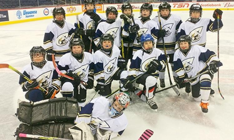 The Atom A Clippers at centre ice at Bell MTS Place