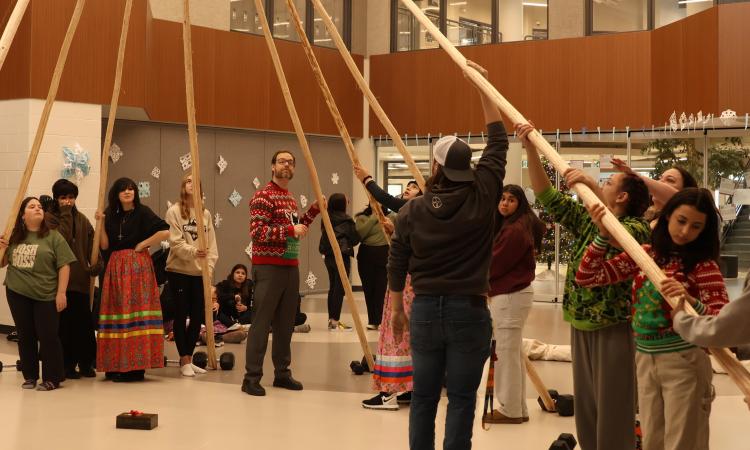 Students gather to erect NHS's teepee.