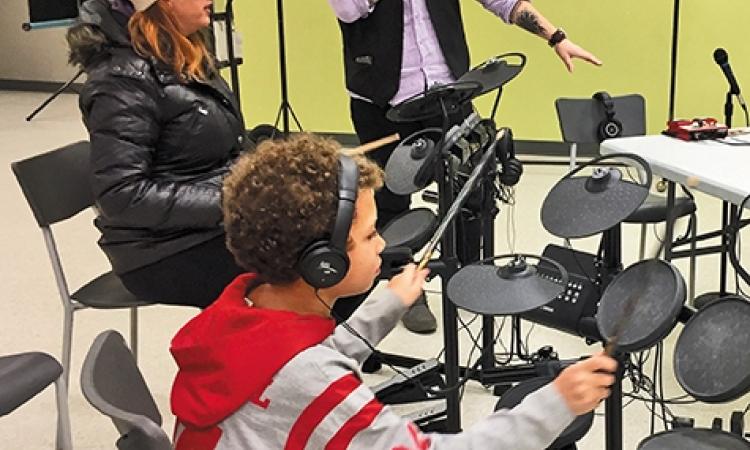Elijah and his mom pick up the sticks at Niverville Winterfest with Kirkwood's encouragement
