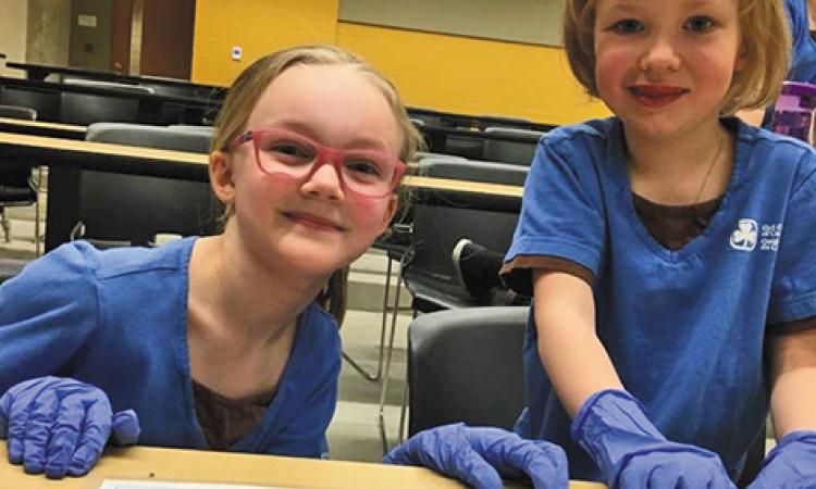 Brownies Erin Beaton and Ryleigh Wachniak attend STEM Day at the University of Manitoba