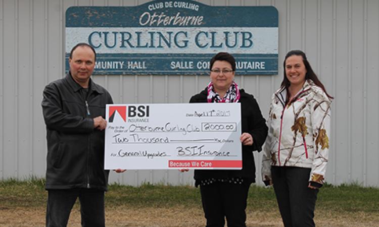 Sharon Martel and Reane Philippot from St. Pierre BSI present a cheque to Albert Poirier, Curling Club Director