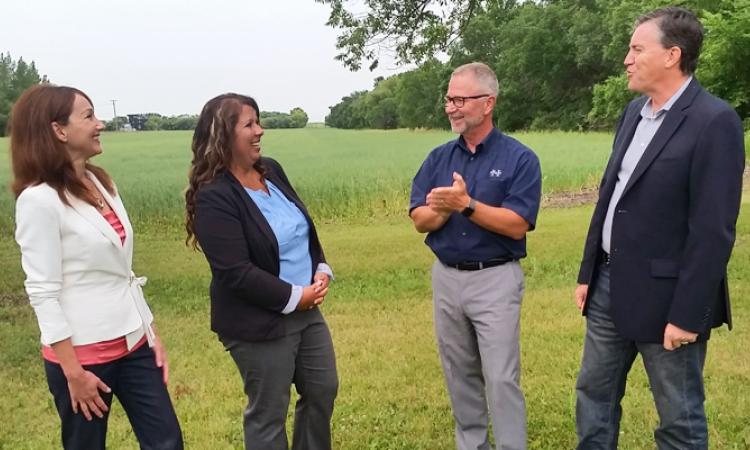 HSD trustees Ruby Wiens and Shannon Friesen with Superintendent Randy Dueck and Niverville mayor Myron Dyck at the site of the future school
