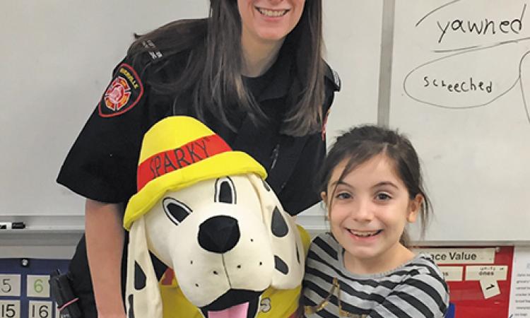 Calysta Guenette poses alongside Sparky the Fire Dog and paramedic firefighter Tara Fehr