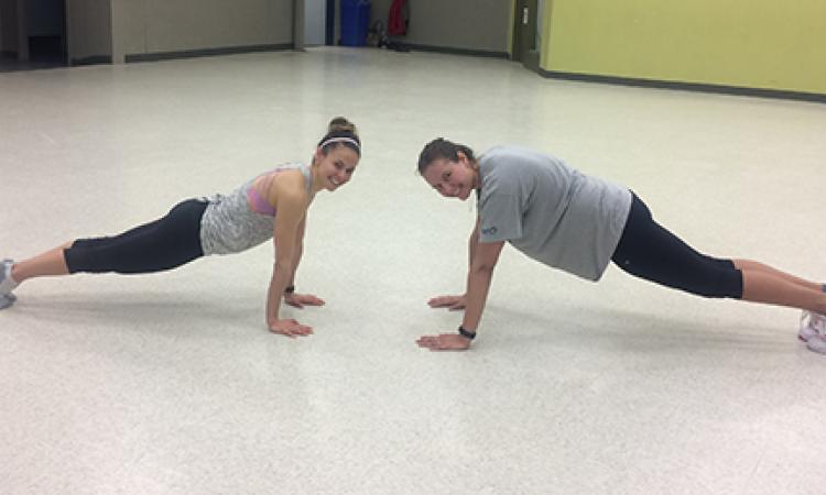 Fitness instructor Mel Smook and Chantel Todd doing a plank