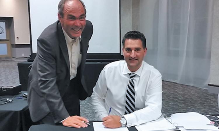 Nathan Dueck getting sworn in by Chief Administrative Officer Jim Buys