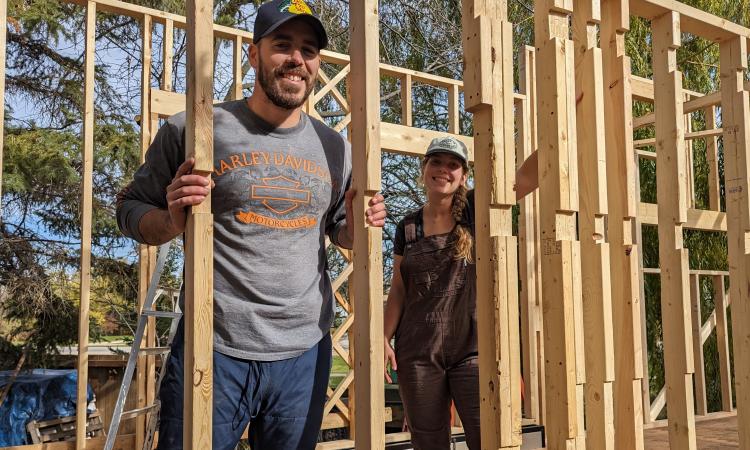 Alexa Sawatzky and her partner Harrison Briand work on their tiny home project.