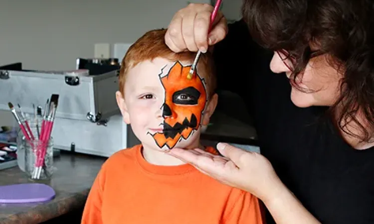 Eileen Davage painting her son Sam's face