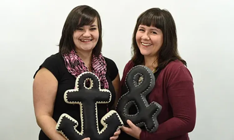 Bethany Speers and Melodie McMahon holding their handmade pillows