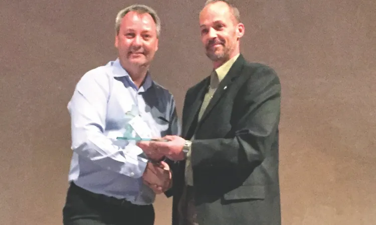 Greg Fehr accepts his award from Jim McMillan