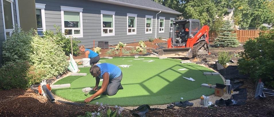 Installing the putting green at the Memory Garden at Niverville's PCH.