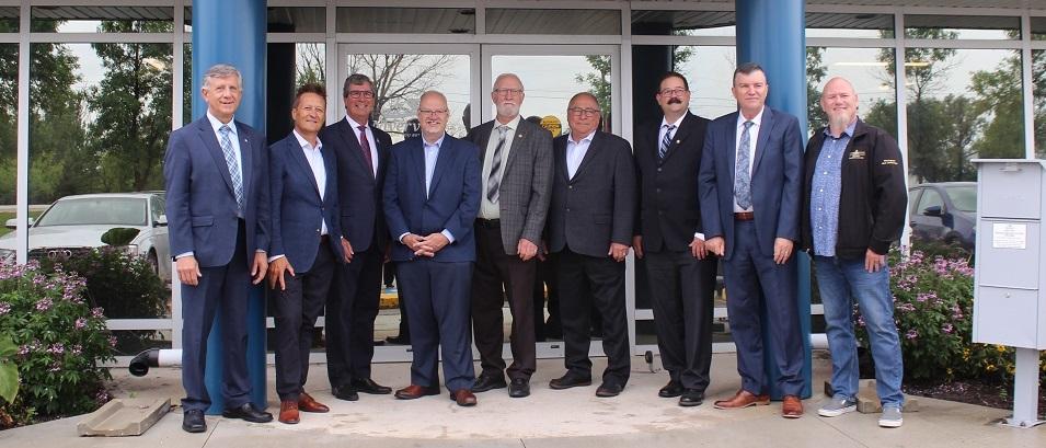 Officials gather in Niverville to announce a major government funding initiative for a cooperative wastewater treatment plan.