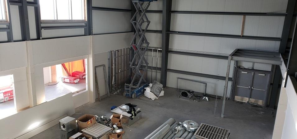 Photo 2: Drywall is being installed in the large foyer area inside the building’s entrance. Once complete, this front area will include an indoor playground.