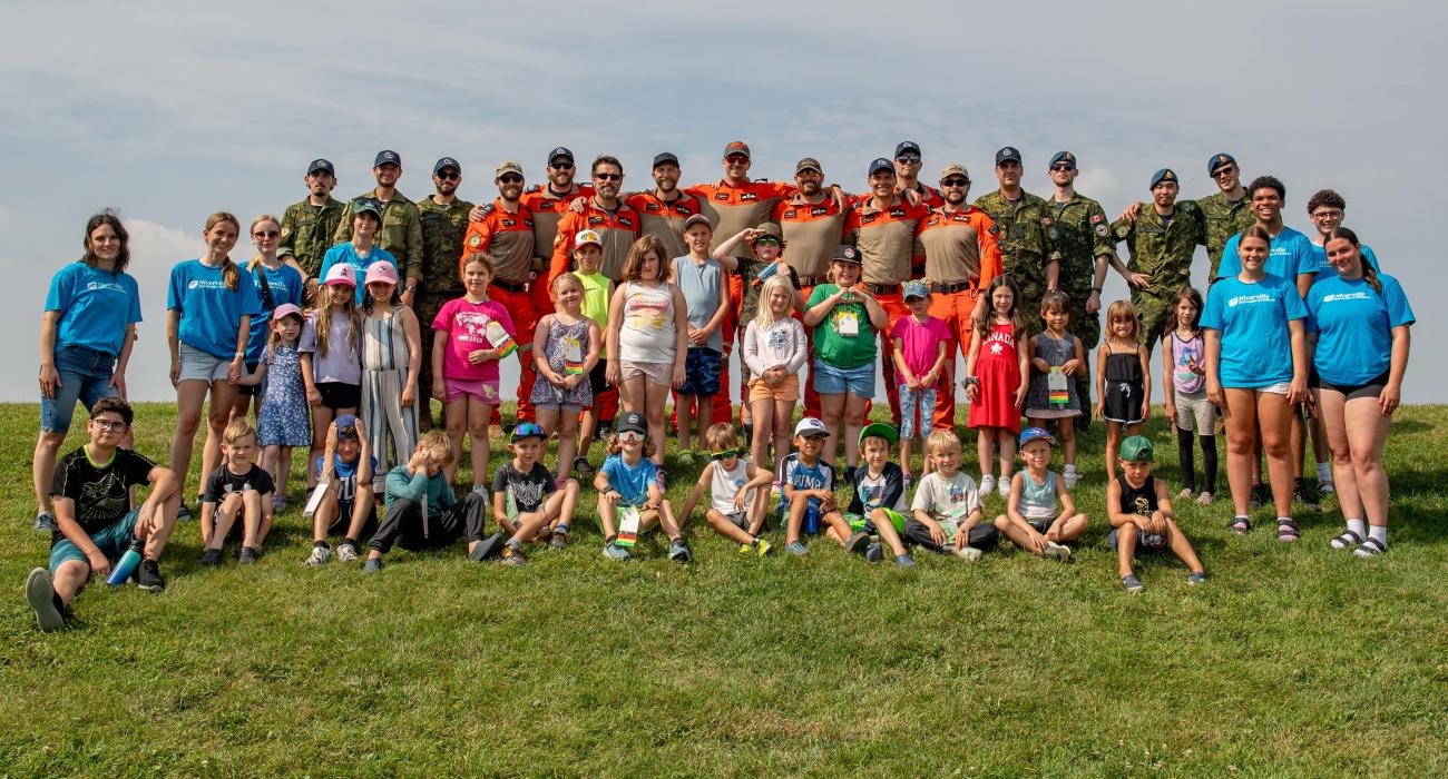 Participants of Niverville's rec adventure camp, ages 6 to 13, pose with RCAF members as part of a simulated emergency response drill.