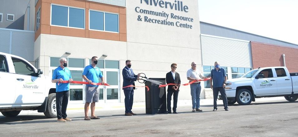 The ribbon-cutting: Councillor Chris Wiebe, Councillor Nathan Dueck, Mayor Myron Dyck, MLA Ron Schuler, Councillor Kevin Stott, and Deputy Mayor John Funk.