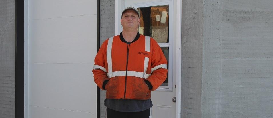 Cameron Bennett outside his blacksmithing shop in St. Adolphe.