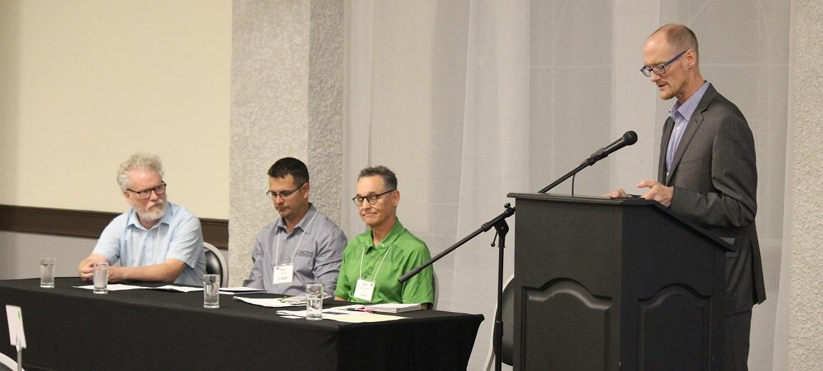 Bruce Duggan of Providence College (Otterburne), Paul Neufeld of Southern Comfort Mechanical (Niverville), and Gary McFarlane of Titan Environment Containment (Île-des-Chênes) speak on a panel moderated by Darren Swanson of the International Institute for Sustainable Development.