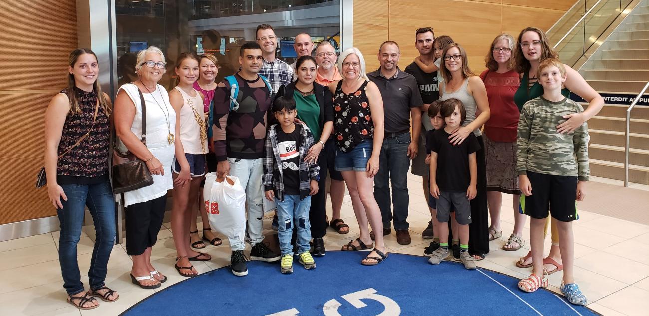 A refugee family is greeted at the Winnipeg airport by members of Open Doors Niverville.