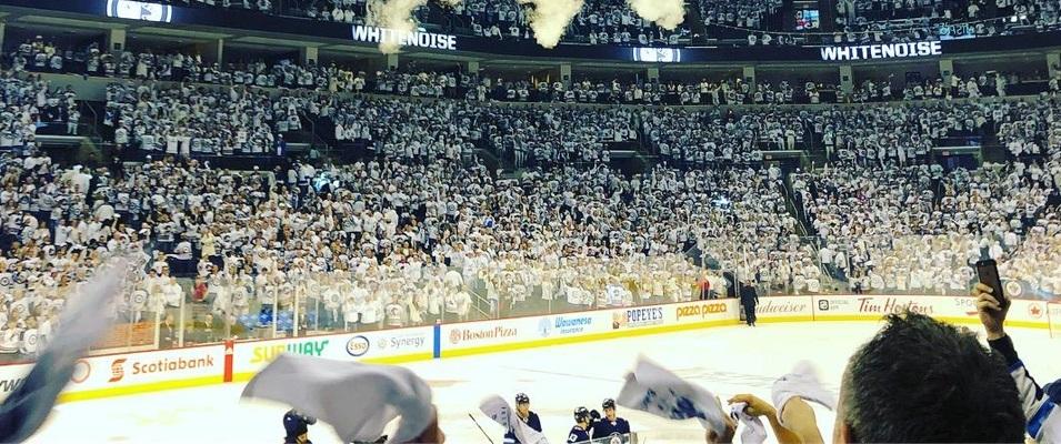 Fans celebrate a Jets victory at Bell MTS Place in Winnipeg.