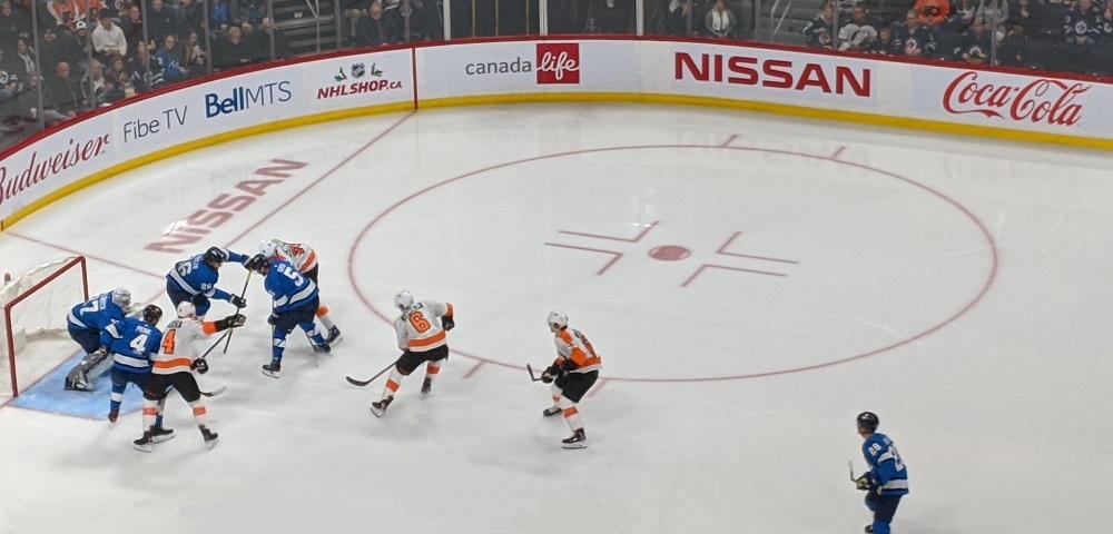 The Jets defend against the Philadelphia Flyers at Bell MTS Place.