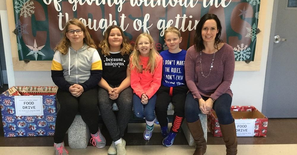 Students Aubrey Kyle, Brianna Johnston, Keira Penner, and Griffen Poettcker with teacher Laurie Loeppky.