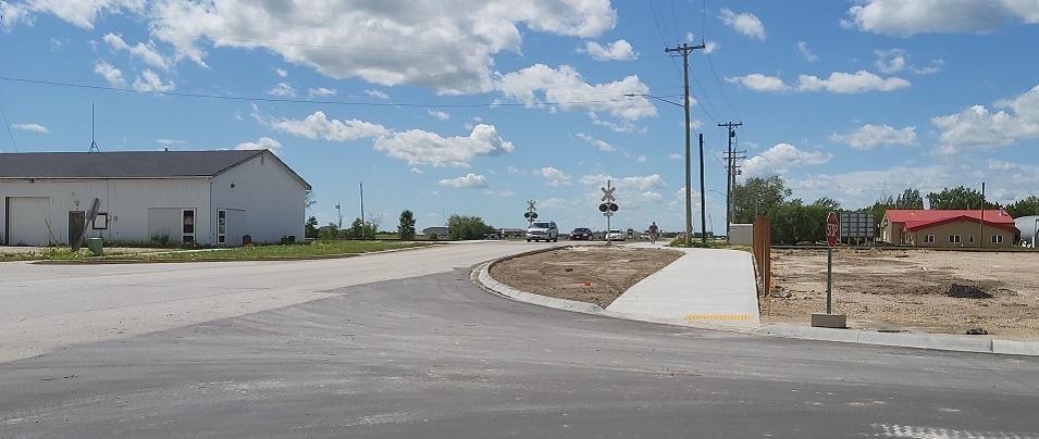 The new sidewalks on the north side of Main Street through the railway crossing.