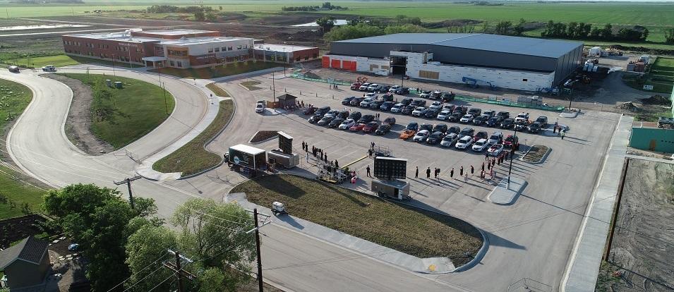 The first-ever crop of Niverville High School graduates comes forward to receive their diplomas at a unique curbside convocation.