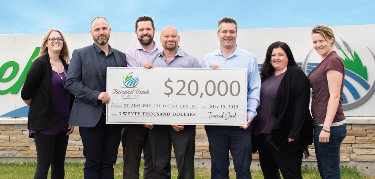 Tourond Creek presents cheque to the St. Adolphe Childcare Centre.