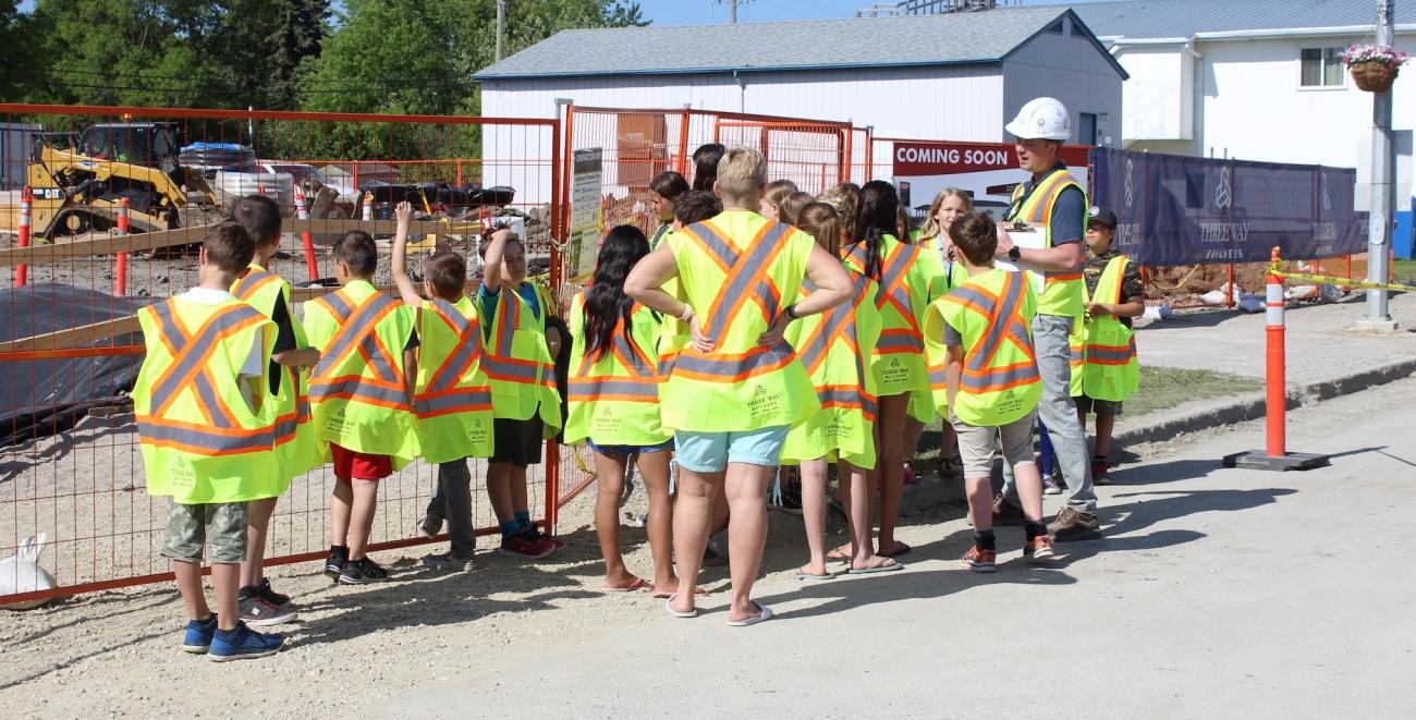 Students gather at the Country Snacks construction site.