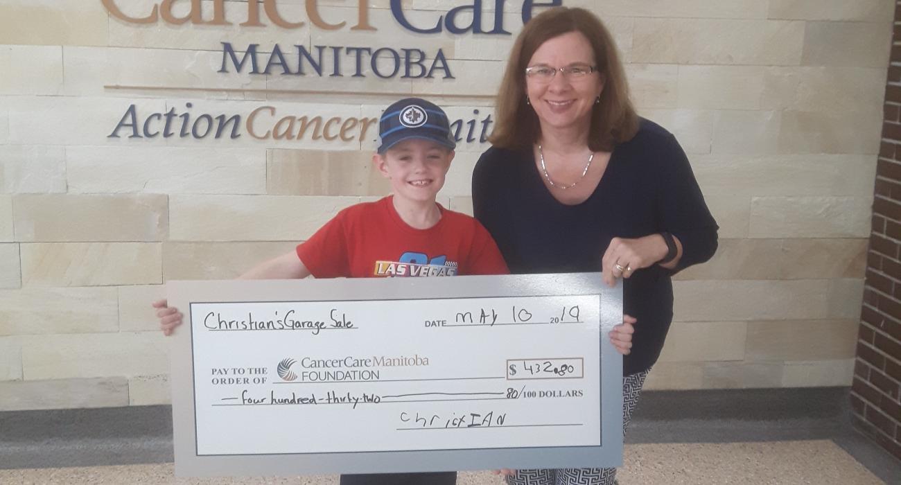 Christian Harder with a staff member from Cancer Care Manitoba.