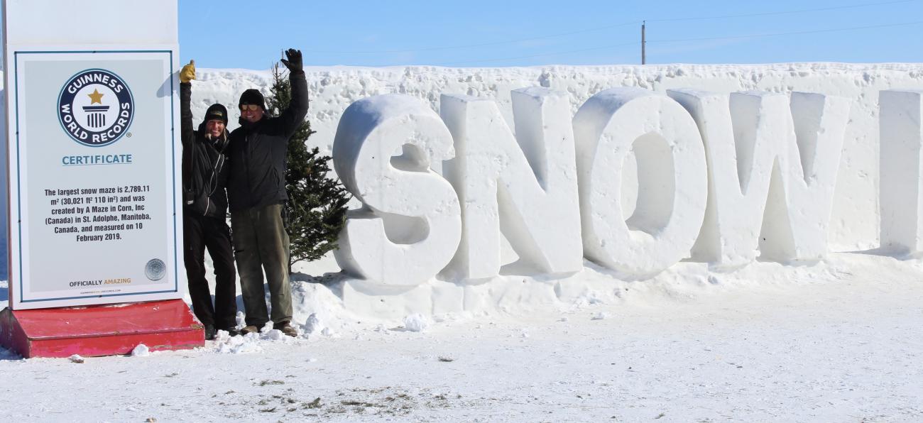 Angie and Clint in front of their record-breaking snow maze near St. Adolphe.