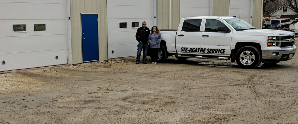 Alain and Rachel Robert in front of their nine-bay shop.