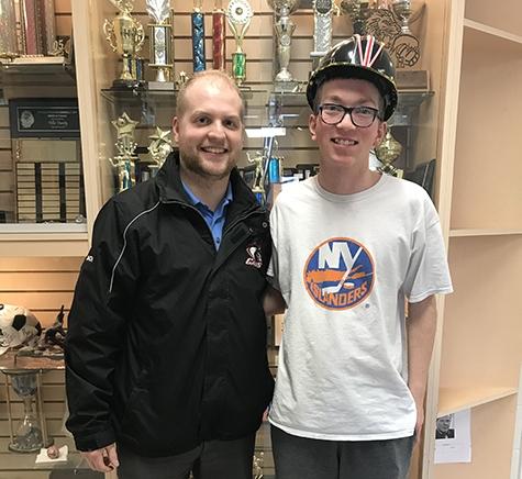 Coach Colin David and Riley Weir, wearing the Cavaliers hardhat.