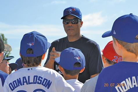 Former Blue Jay Roberto Alomar working with young players at the 2016 baseball camp.