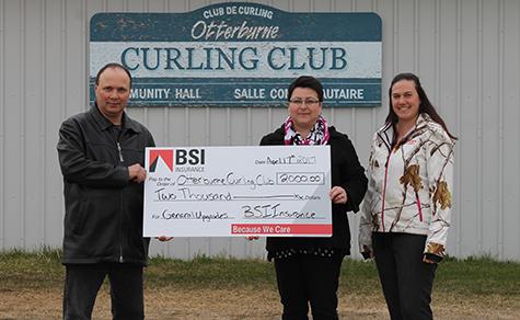 Sharon Martel and Reane Philippot from St. Pierre BSI present a cheque to Albert Poirier, Curling Club Director