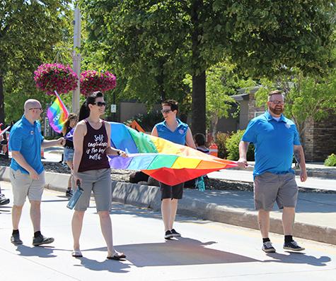 Michelle McHale and Chris Plett lead hundreds of marchers at the second annual Steinbach Pride parade