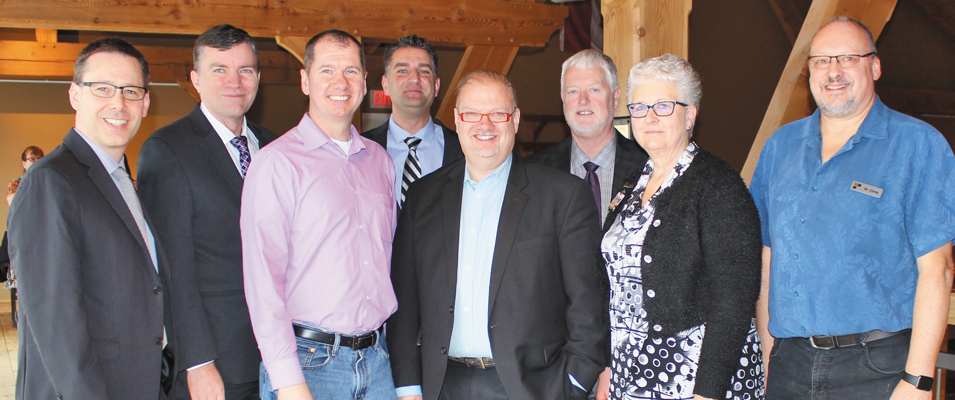 Gord Daman, Myron Dyck, Shannon Martin, Nathan Dueck, Kelvin Goertzen, Abe Bergen, Kathy McPhail, and Dr. Chris Burnett at Open Health facility tour