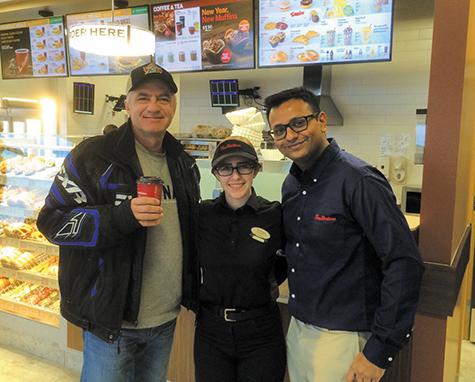 Ken Krahn receives the first cup of coffee at Niverville's new Tim's
