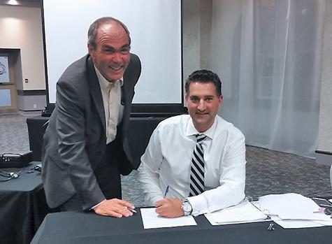 Nathan Dueck getting sworn in by Chief Administrative Officer Jim Buys