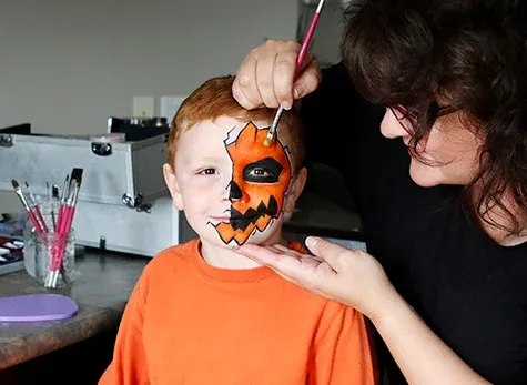 Eileen Davage painting her son Sam's face