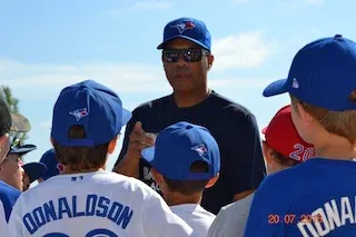 Former Blue Jay Roberto Alomar working with young players at this year's baseball camp