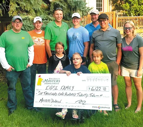 Joel Martens, Tyler Wiebe, Ray Dowse, Stanley Hiebert, and Collin Funk present a cheque to the Eidse family of Niverville